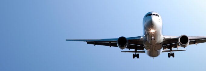 view of an airplane flying overhead from the ground