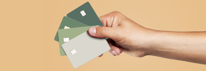 Hand holding a fan of 4 credit cards